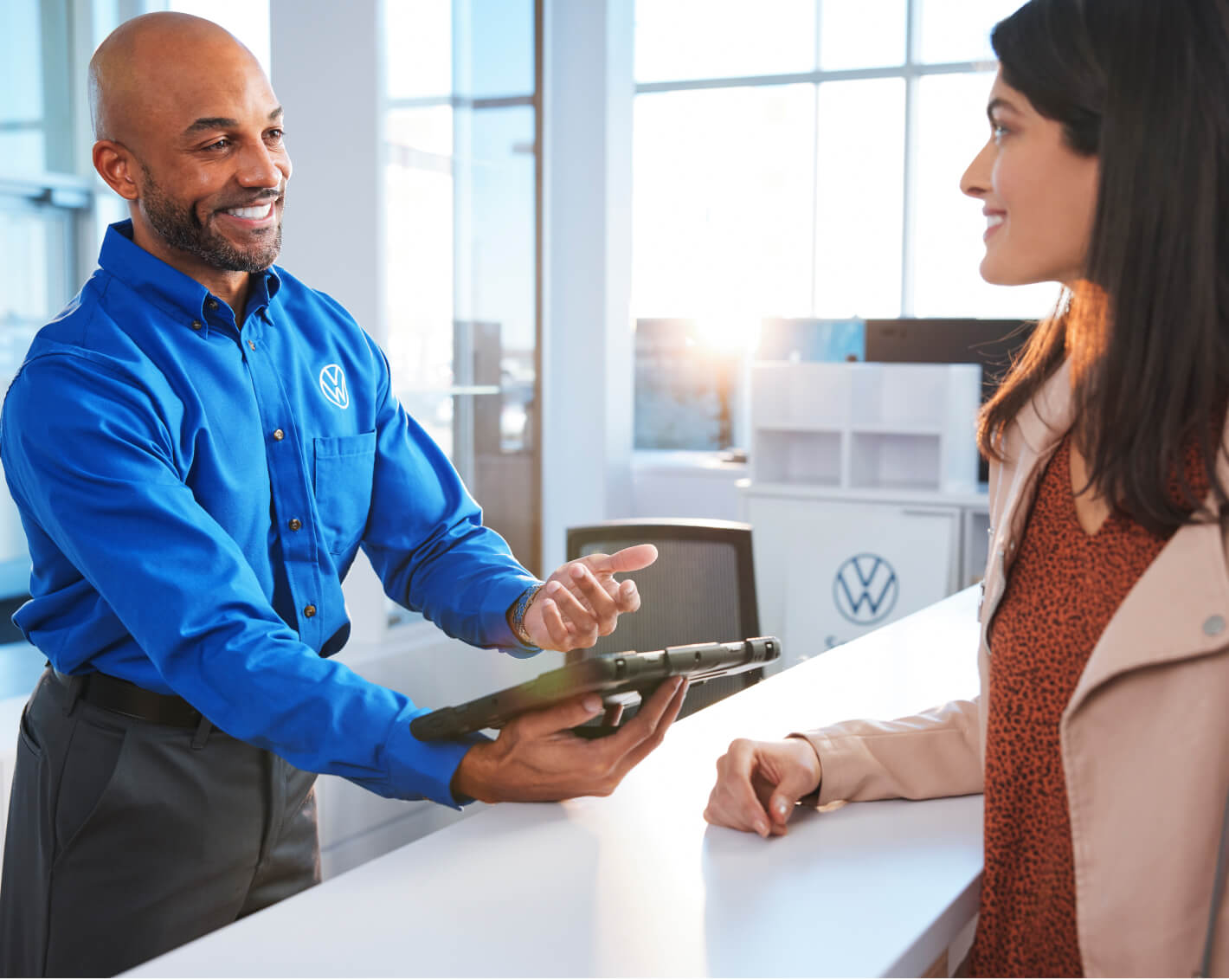 VW Sales Associate Speaking with Customer